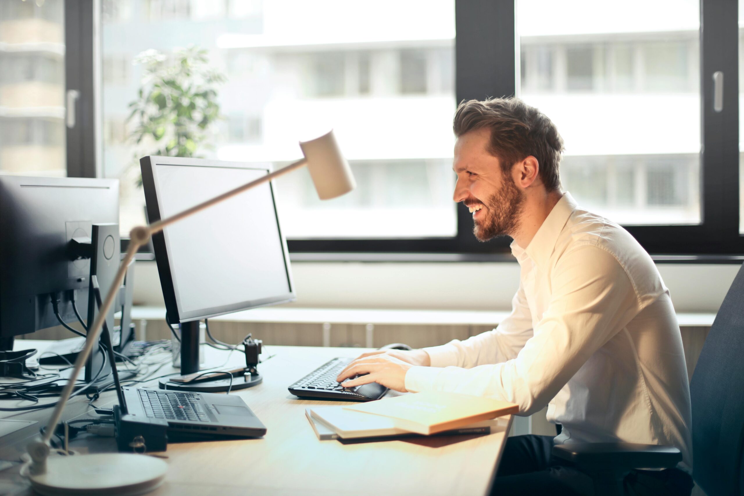 A sales outreach professional sitting at his desk.